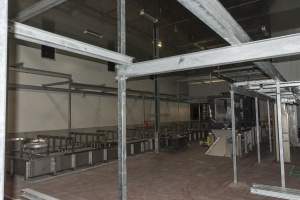 New killing/processing building containing large long scalding tank - Under construction at time of photos (2015). Gondolas much larger to gas many more pigs at once. Side of chamber opens, wall closes in to push pigs into gondola. - Captured at JBS Pork Australia (formerly Diamond Valley Pork), Laverton North VIC Australia.