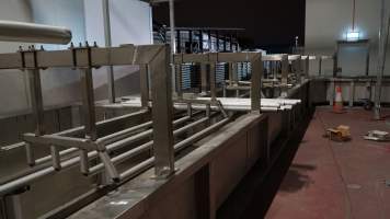 New killing/processing building containing large long scalding tank - Under construction at time of photos (2015). Gondolas much larger to gas many more pigs at once. Side of chamber opens, wall closes in to push pigs into gondola. - Captured at JBS Pork Australia (formerly Diamond Valley Pork), Laverton North VIC Australia.
