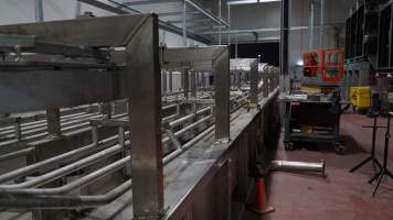 New killing/processing building containing large long scalding tank - Under construction at time of photos (2015). Gondolas much larger to gas many more pigs at once. Side of chamber opens, wall closes in to push pigs into gondola. - Captured at JBS Pork Australia (formerly Diamond Valley Pork), Laverton North VIC Australia.