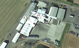 Aerial of facility from rear - This is an aerial photo of pigs being unloaded from transport.