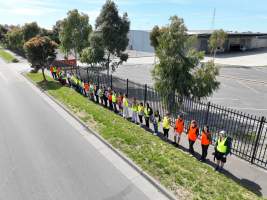 Drone shot of activist standing in line, outside of Diamond Valley Pork - Taken at Diamond Valley Pork as part of the Melbourne Vegan Takeover - Day of Action for Animals - Captured at JBS Pork Australia (formerly Diamond Valley Pork), Laverton North VIC Australia.