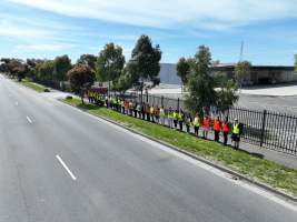 Drone shot of activist standing in line, outside of Diamond Valley Pork - Taken at Diamond Valley Pork as part of the Melbourne Vegan Takeover - Day of Action for Animals - Captured at JBS Pork Australia (formerly Diamond Valley Pork), Laverton North VIC Australia.