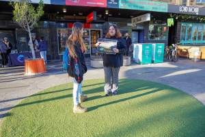 5 Question Challenge: Dominion Outreach Melbourne: 15 June 2025 - Animal rights activists participating in a street outreach event in St Kilda, Victoria, Australia. Some volunteers hold placards inviting pedestrians to answer 5 questions in exchange for a vegan treat. Others hold TVs showing footage from Farm Transparency Project's dairy investigations. Together, they bring awareness to the hidden reality of what happens to cows, calves, and bulls in the Australian dairy industry. - Captured at VIC.