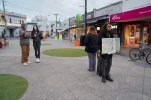 5 Question Challenge: Dominion Outreach Melbourne: 15 June 2025 - Animal rights activists participating in a street outreach event in St Kilda, Victoria, Australia. Some volunteers hold placards inviting pedestrians to answer 5 questions in exchange for a vegan treat. Others hold TVs showing footage from Farm Transparency Project's dairy investigations. Together, they bring awareness to the hidden reality of what happens to cows, calves, and bulls in the Australian dairy industry. - Captured at VIC.