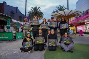 5 Question Challenge: Dominion Outreach Melbourne: 15 June 2025 - Animal rights activists participating in a street outreach event in St Kilda, Victoria, Australia. Some volunteers hold placards inviting pedestrians to answer 5 questions in exchange for a vegan treat. Others hold TVs showing footage from Farm Transparency Project's dairy investigations. Together, they bring awareness to the hidden reality of what happens to cows, calves, and bulls in the Australian dairy industry. - Captured at VIC.
