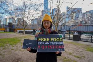 22 June 2025: 5 Question Challenge: Dominion Outreach Melbourne - Animal rights activists participating in a street outreach event in Southbank, Victoria, Australia. Some volunteers hold placards inviting pedestrians to answer 5 questions in exchange for a vegan treat. Others hold TVs showing footage from Farm Transparency Project's dairy investigations. Together, they bring awareness to the hidden reality of what happens to cows, calves, and bulls in the Australian dairy industry. - Captured at VIC.