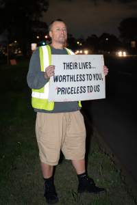 Cedar Meats Vigil - National Week Of Action 2025 - During the Shut Down Slaughterhouses Week of Action, we held a vigil outside of the Cedar Meats slaughterhouse in Brooklyn, Victoria.
During a two week investigation last year, our hidden cameras captured the handling and slaughter of animals, including newborn lambs and kids born in the holding pens of the slaughterhouse.
It was a Wednesday night when we gathered outside the slaughterhouse, holding signs and listening to music and speeches from investigators. We wanted to send a message to Cedar Meats, to let them know that we have not forgotten how they treat animals when they believe that no one is watching
We poured fake blood across their driveway as a visual reminder to everyone passing by, that animals arriving here are coming to their deaths. At the gates to the slaughterhouse, we each left a flower.
The images of animals whose deaths we have seen will haunt us forever, but we are determined to continue to fight in their name. - Captured at Cedar Meats, Brooklyn VIC Australia.